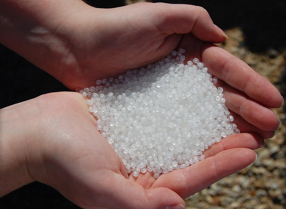 Plastic pellets held in hands