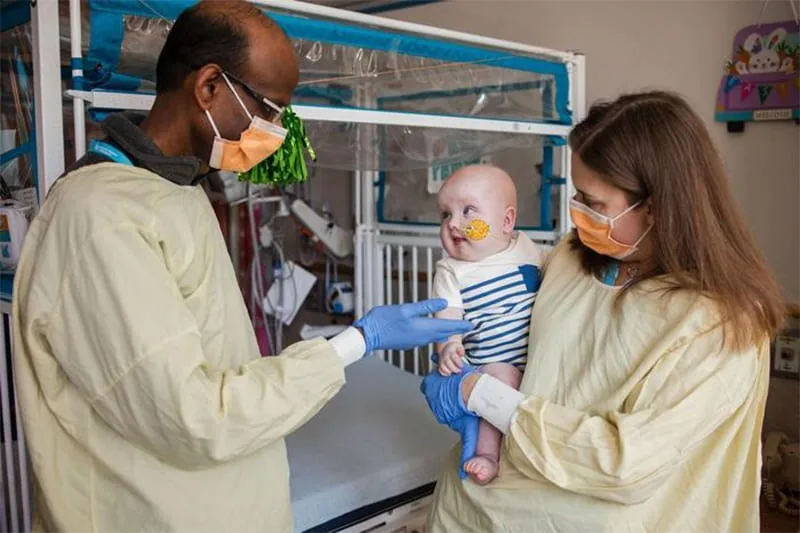 Clinical researchers caring for a child
